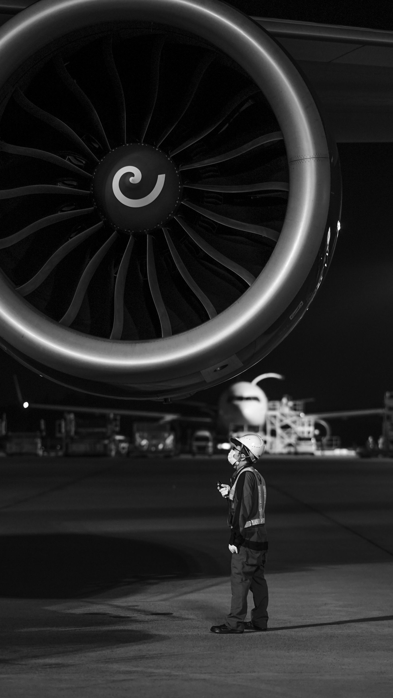Engineer beside a turbine at night