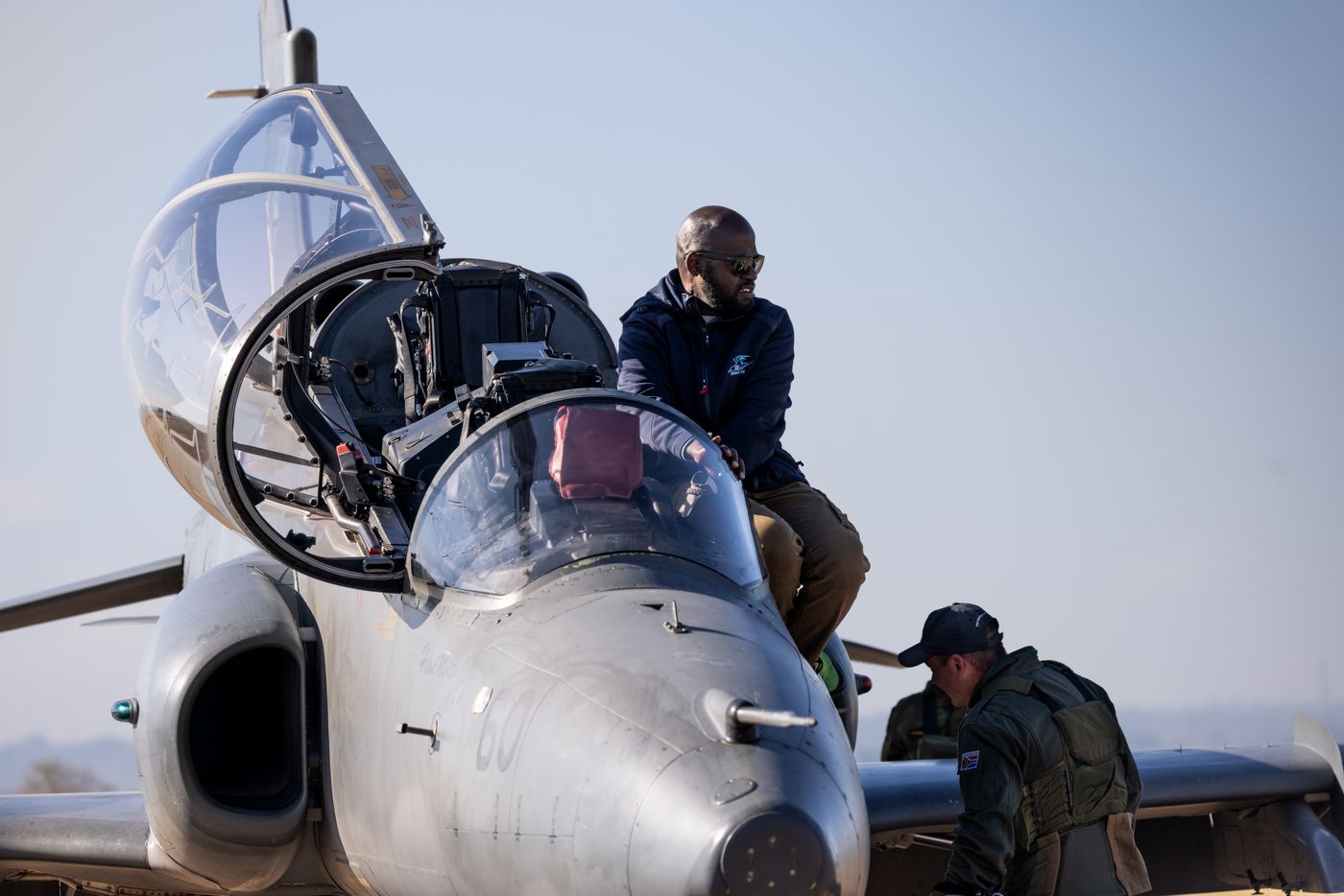 An aircraft engineer working on a jet during maintenance